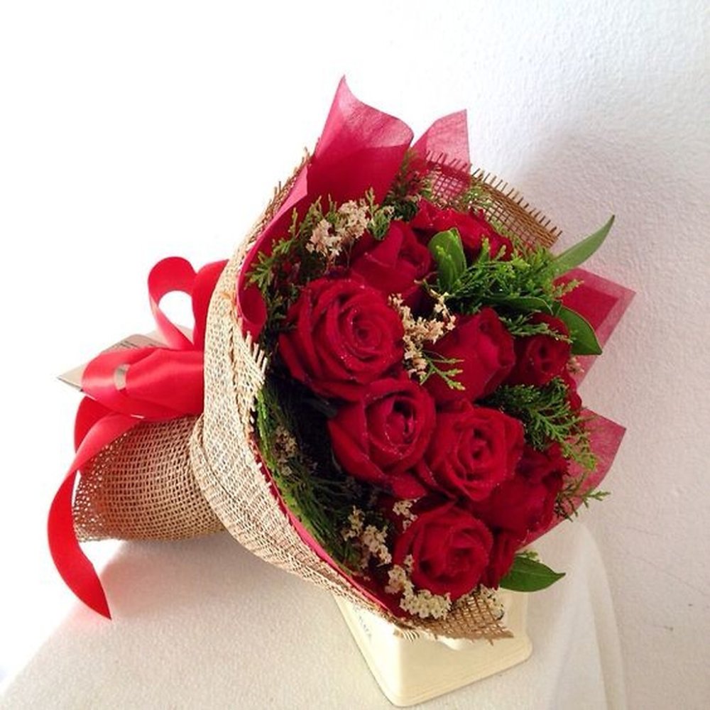Red roses bouquet with burlap wrap