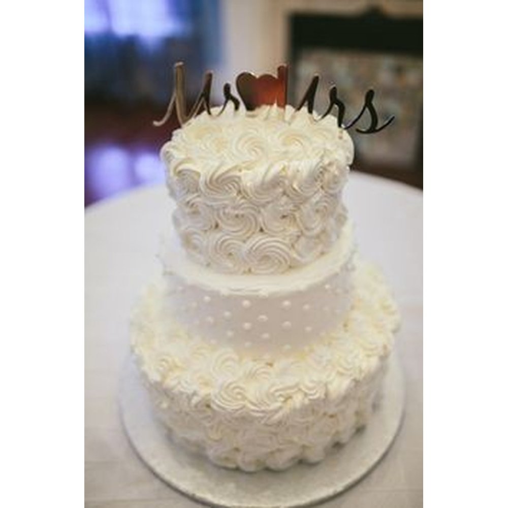 Three-tier white rosette wedding cake