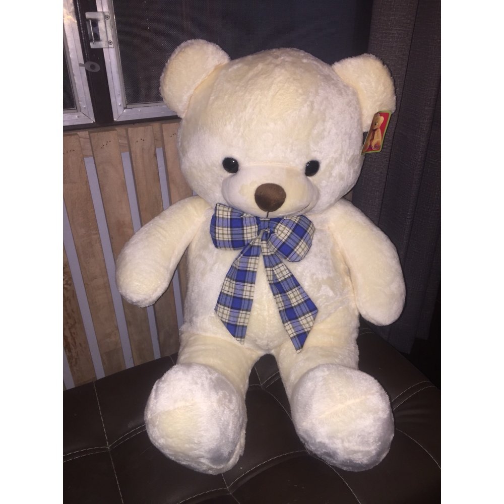 Oso de peluche crema con lazo azul