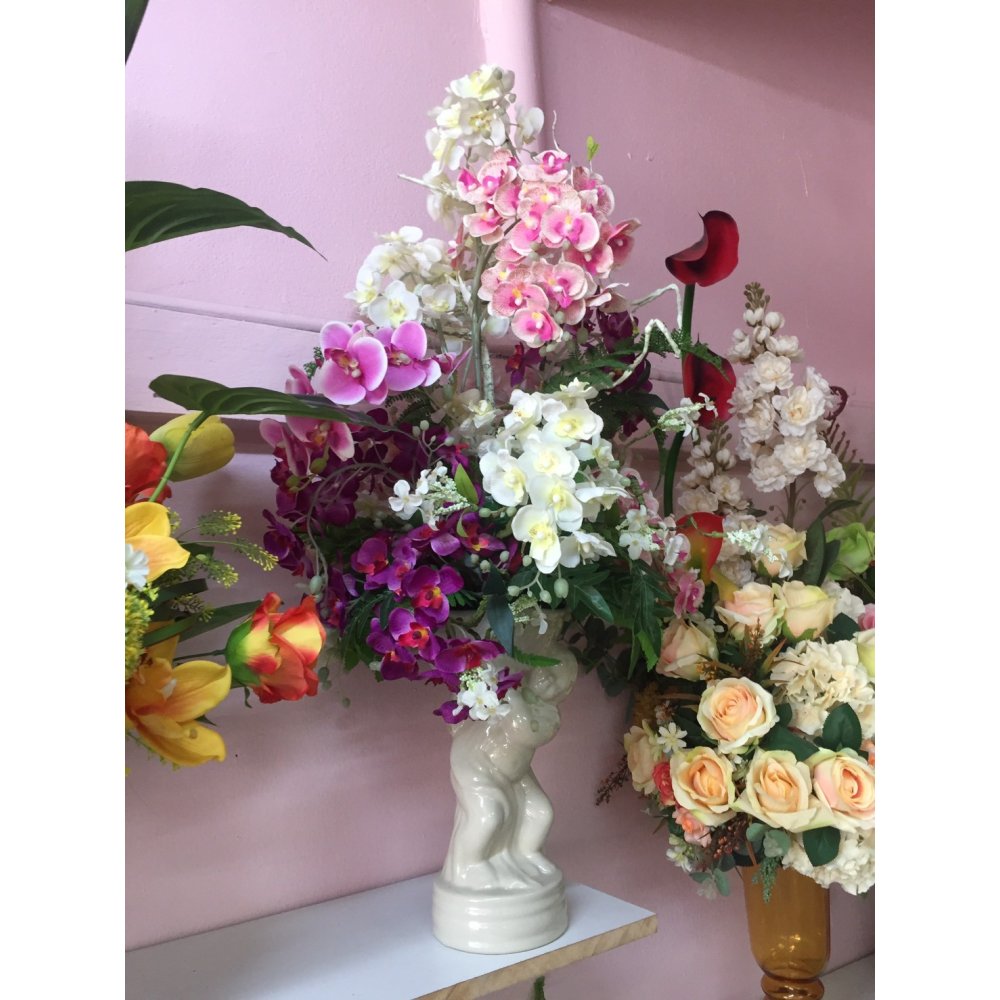 Artificial flowers in glass vase