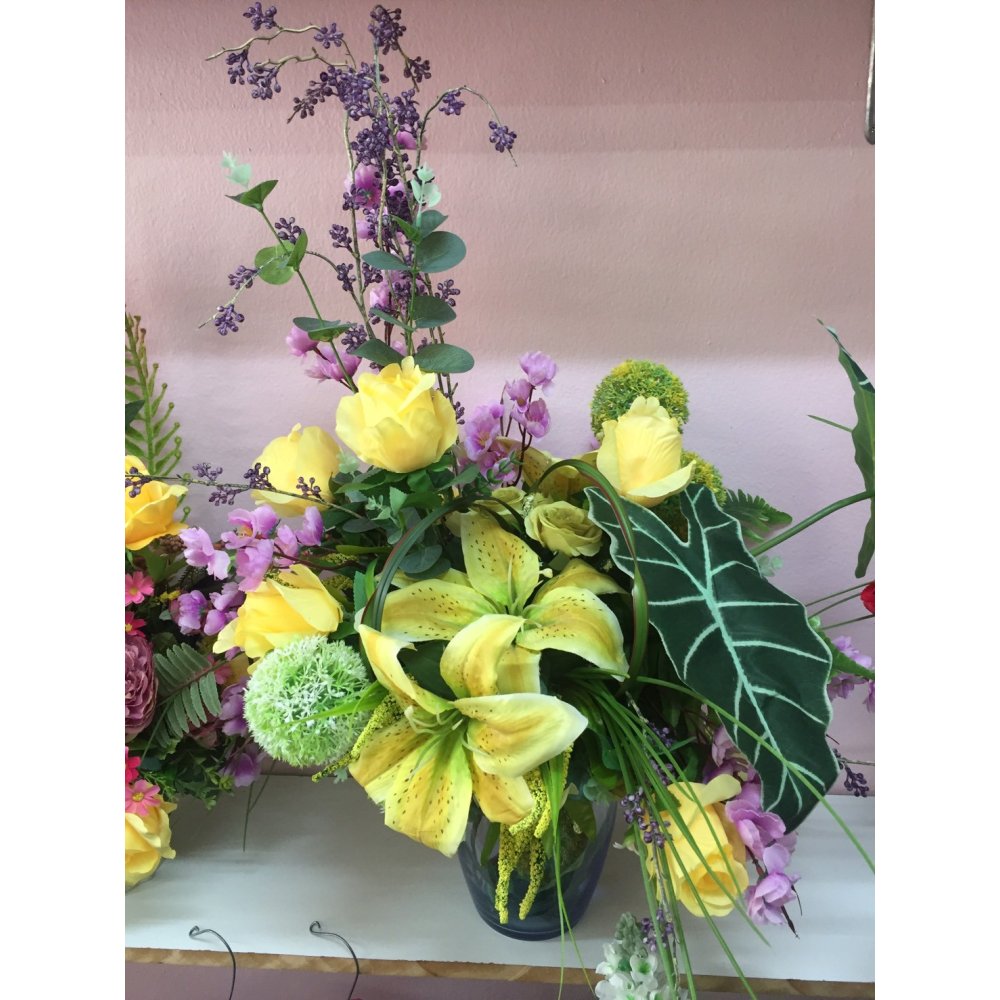 Artificial flowers in glass vase