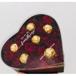 Artificial flowers in box with chocolate