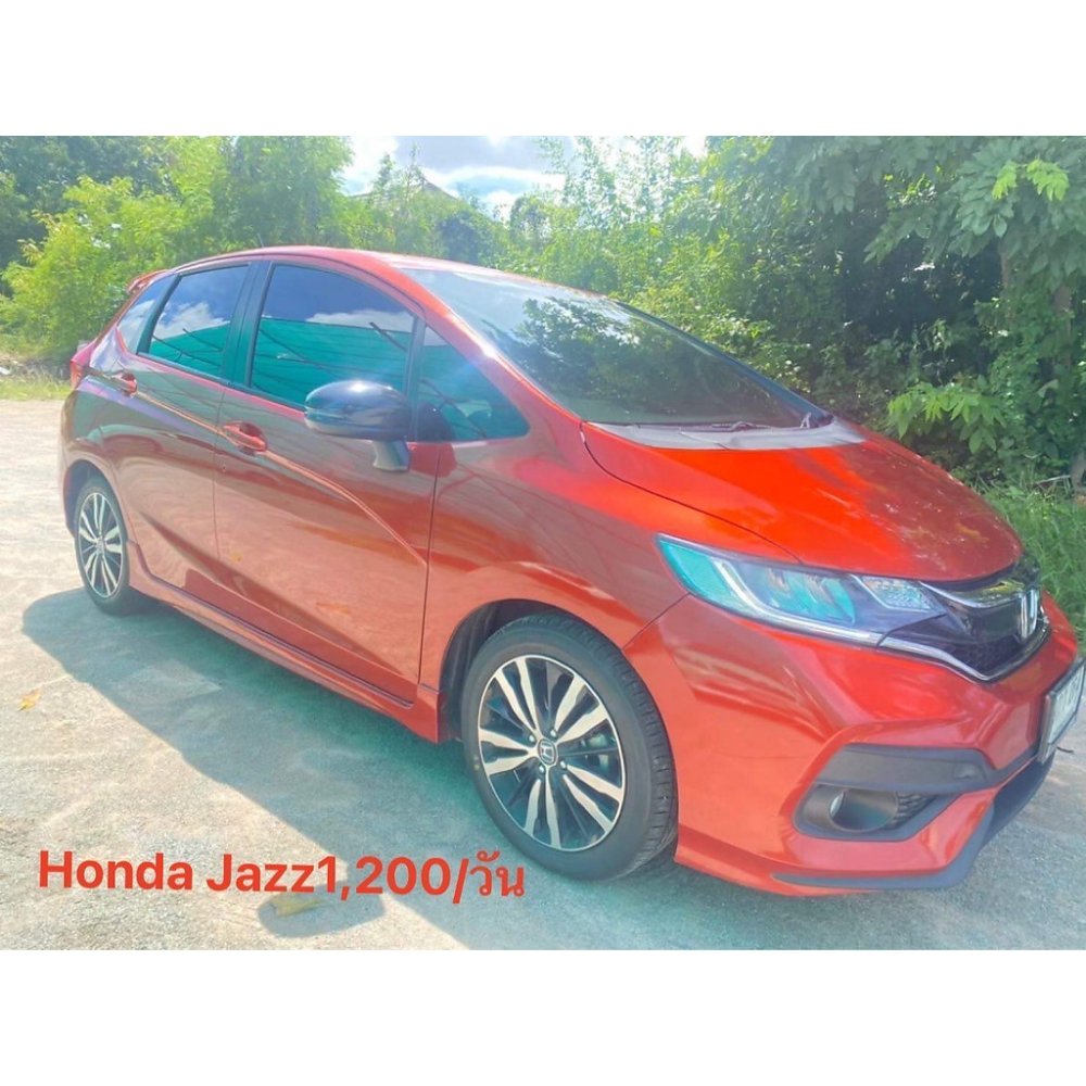 Red Honda Jazz hatchback car